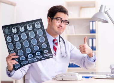 Hastane odasında çalışan yakışıklı genç bir doktor.