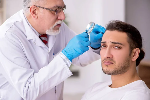 Young man visiting experienced doctor dermatologist — Stock Photo, Image