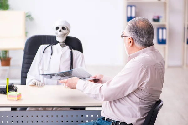 Old man visiting dead doctor radiologist — Stock Photo, Image