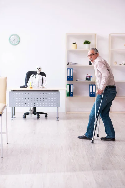 Gammal ben skadad man besöker död läkare — Stockfoto