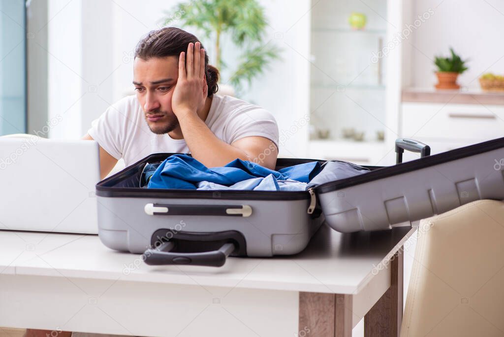 Young man preparing for departure at home