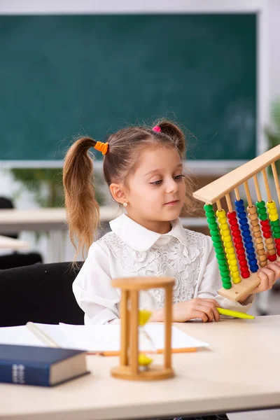 Kleines Mädchen mit Abakus im Klassenzimmer — Stockfoto