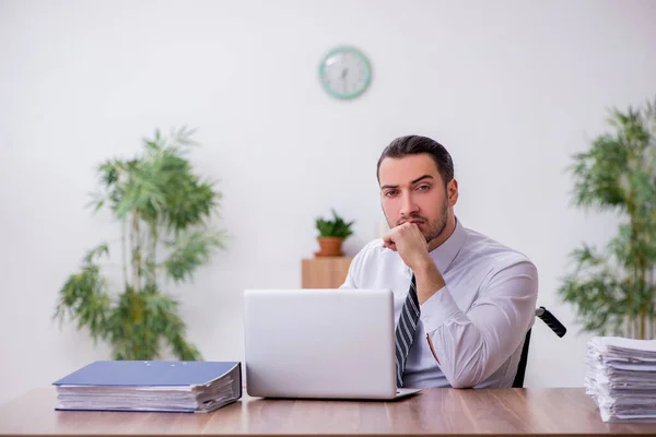 Young disabled employee suffering at workplace