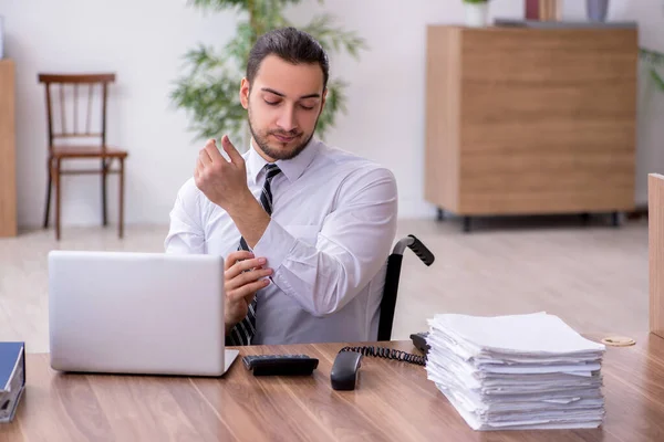 Young disabled employee suffering at workplace