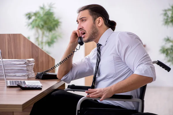 Young disabled employee suffering at workplace