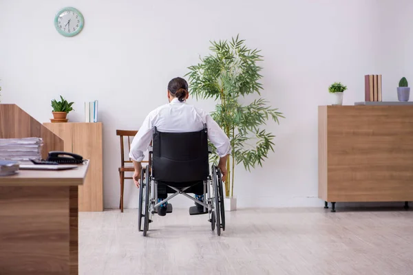 Young disabled employee suffering at workplace