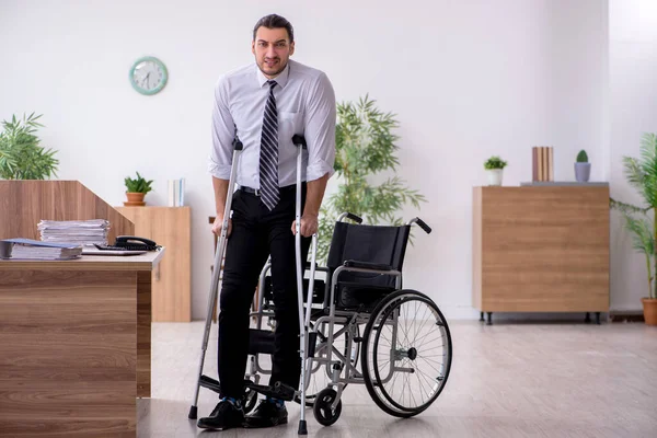 Young disabled employee suffering at workplace