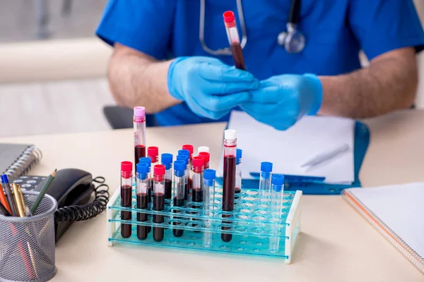 Old male doctor working in the clinic — Stock Photo, Image