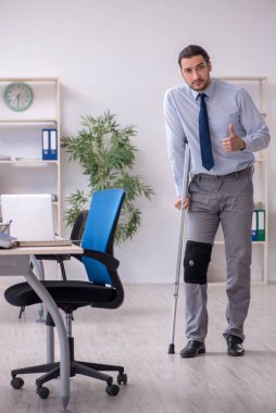 Ofiste çalışan genç bacağı yaralı bir çalışan.