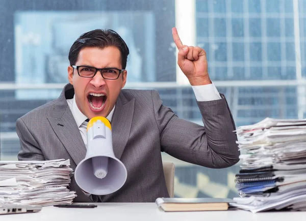 Angry businessman with loudspeaker in the office — Stock Photo, Image