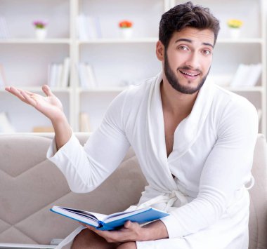 Öğrenci işadamı genç adam bir kitap okuyor.