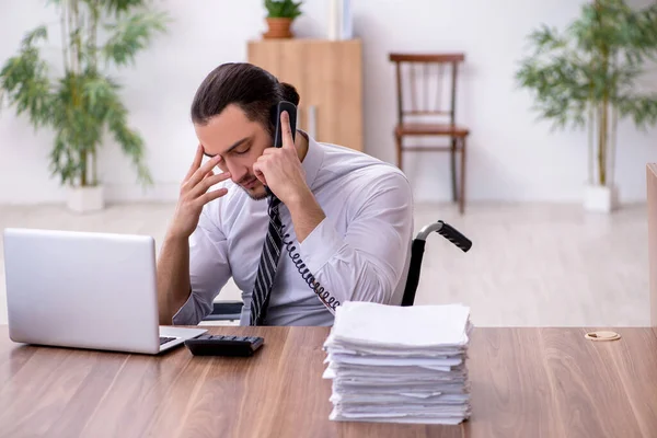 Young disabled employee suffering at workplace