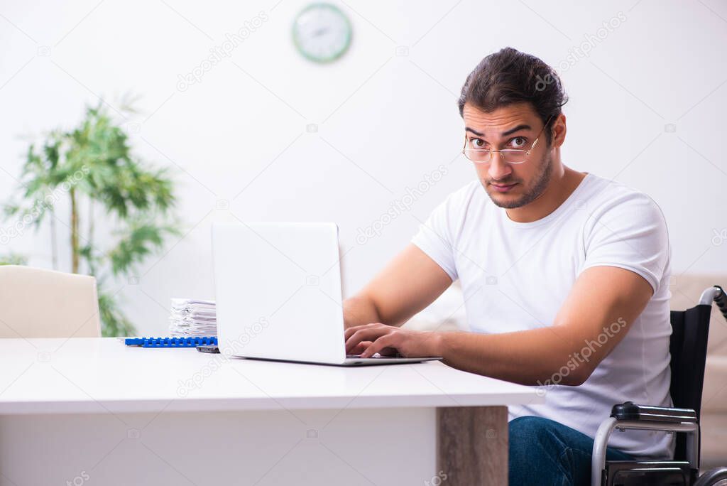 Young disabled man working from house