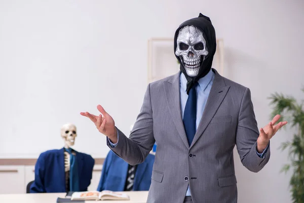 Funny business meeting with devil and skeletons