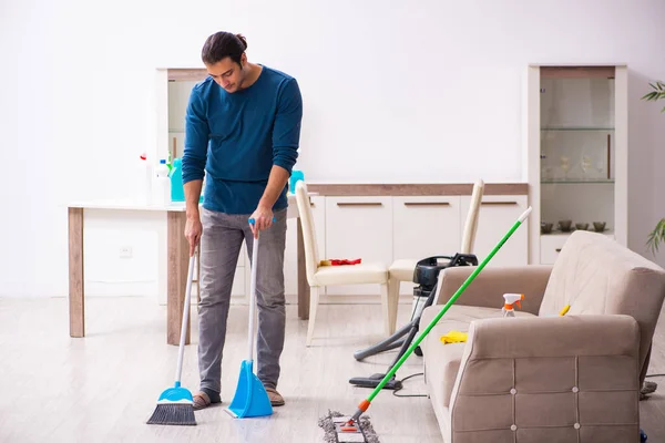 Jongeman doet huishoudelijk werk thuis — Stockfoto