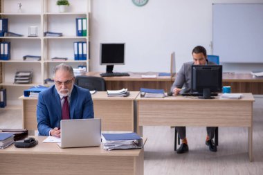 Ofiste çalışan iki erkek çalışan.