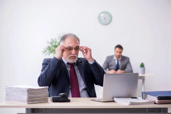 Ancien patron et son jeune assistant travaillant dans le bureau — Photo