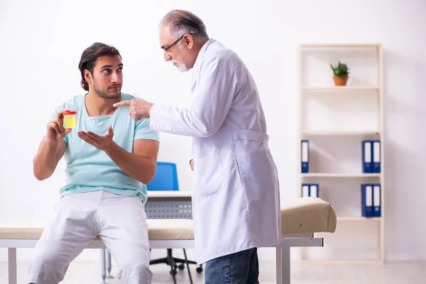 Young male patient visiting experienced doctor — Stock Photo, Image