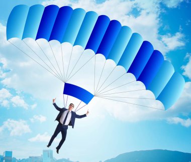 Genç işadamı iş konseptinde paraşütle atlıyor