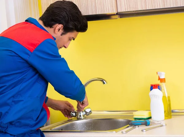 Rörmokare reparerar kranen i köket — Stockfoto