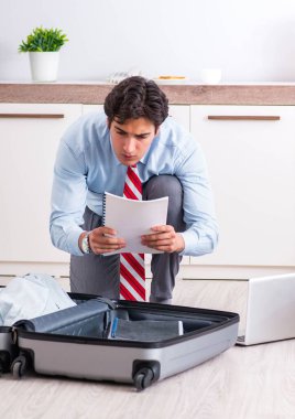 Genç yakışıklı iş adamı yolculuğa hazırlanıyor.