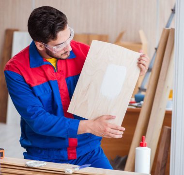 Tamirci, boyayla uğraşan marangoz.