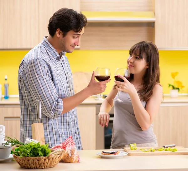 Young couple celebrating wedding anniversary at kitchen — Stock Photo, Image