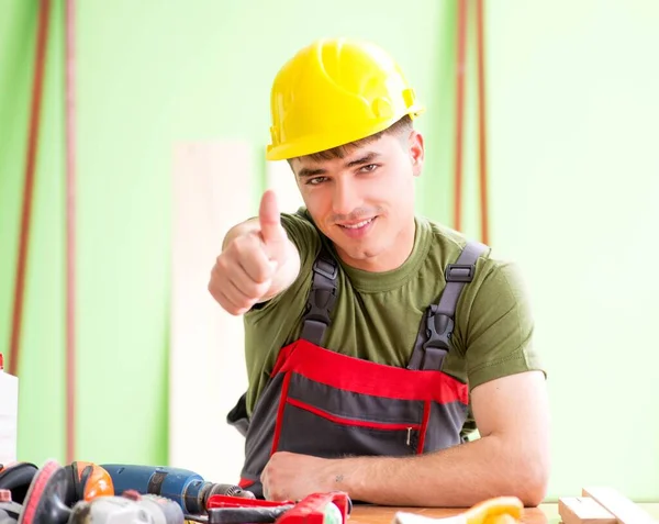 Young man carpenter working in workshop — Stock Photo, Image