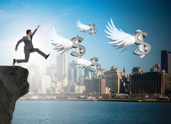 Empresario persiguiendo dólares ángel en concepto de negocio —  Fotos de Stock