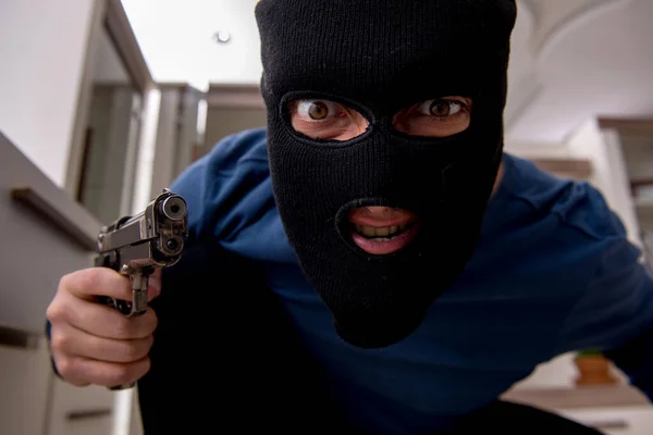 Male robber stealing valuable things from the house — Stock Photo, Image