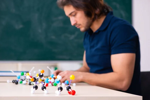 Young male scientist sitting in the classroom — Stock Photo, Image