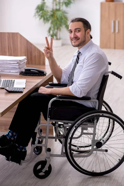 Young disabled employee suffering at workplace