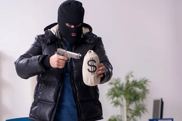 Young male burglar in the office — Stock Photo, Image