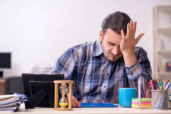 Young male student sitting in the classroom — Stock Photo, Image