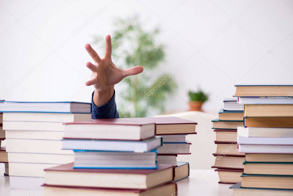 Young male student preparing for exams at home