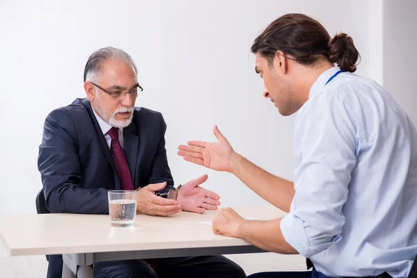 Old businessman meeting with advocate in pre-trial detention — Stock Photo, Image