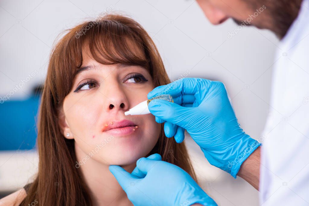 Young woman visiting male doctor dermatologist