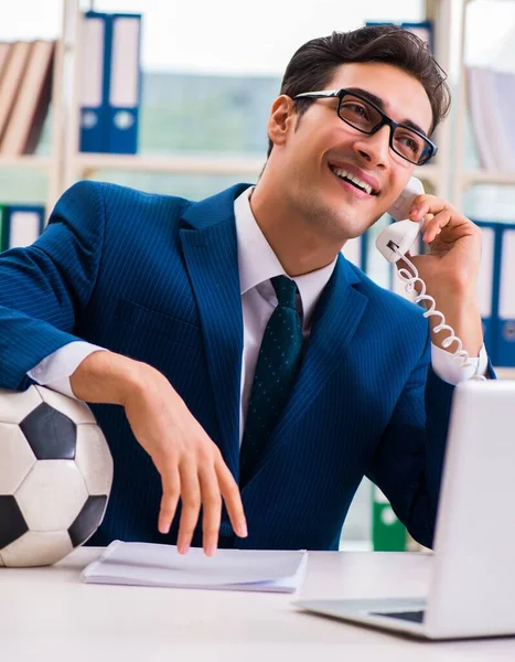 Businessman playing football in the office — Stock Photo, Image