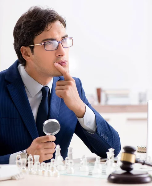 Young lawyer playing chess to train his court strategy and tacti