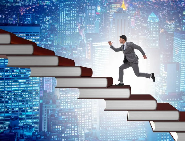 Businessman student climbing the ladder of education books — Stock Photo, Image