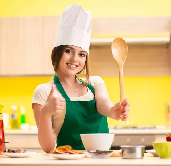 Jonge vrouw bereidt salade thuis in de keuken — Stockfoto