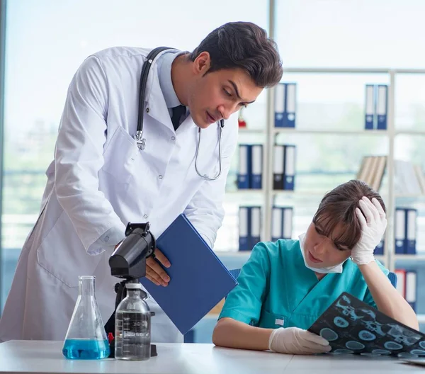 Two doctors discussing x-ray MRI image in hospital — Stock Photo, Image