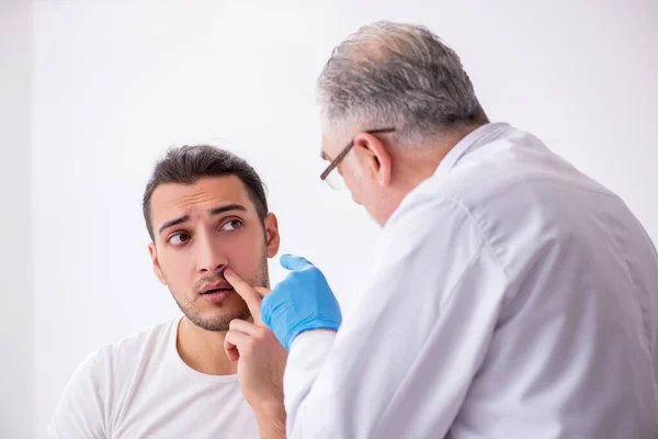 Young man visiting experienced doctor dermatologist — Stock Photo, Image