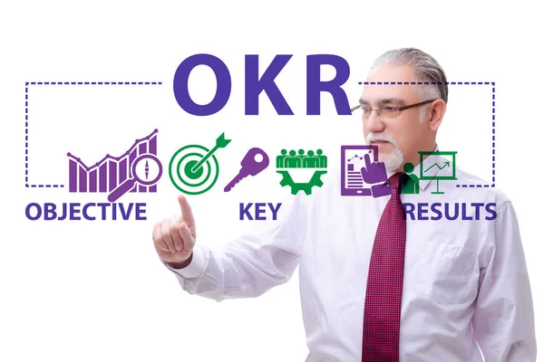 Concepto OKR con resultados clave objetivos y empresario —  Fotos de Stock