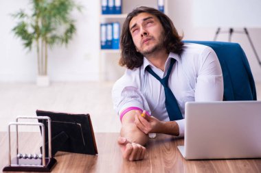 Ofiste çalışan uyuşturucu bağımlısı bir erkek.