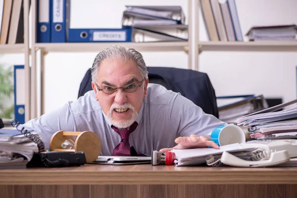 Velho funcionário do sexo masculino infeliz com trabalho excessivo — Fotografia de Stock