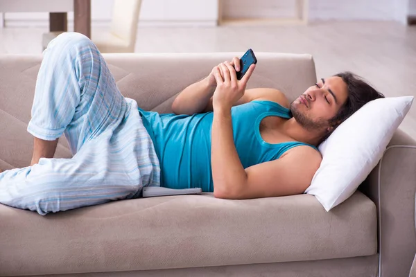 Young man waking up at home — Stock Photo, Image