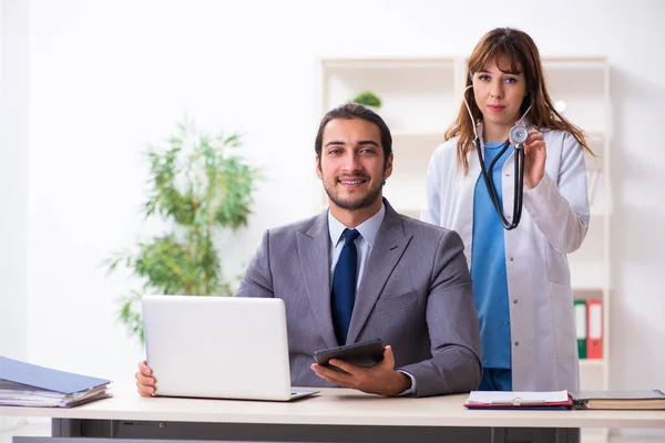 Mujer joven médico y empresario enfermo en la oficina —  Fotos de Stock