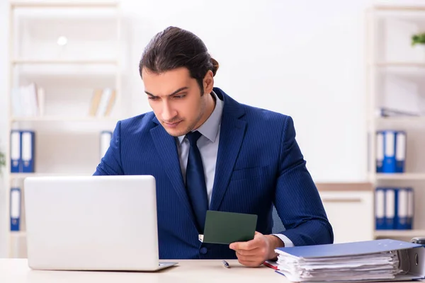 Young man checking passport in the office — Stock Photo, Image