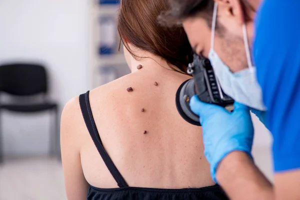 Jovem mulher visita médico dermatologista masculino — Fotografia de Stock